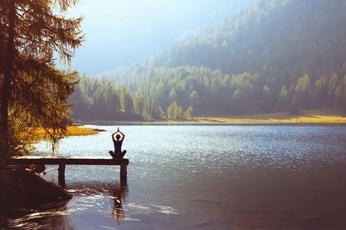 Mental Health & wellbeing - yoga by a scenic lake