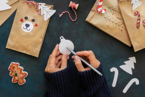flat-lay-hands-decorating-christmas-gift-bags