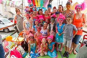 Group of parents and children dressed up for a carnival