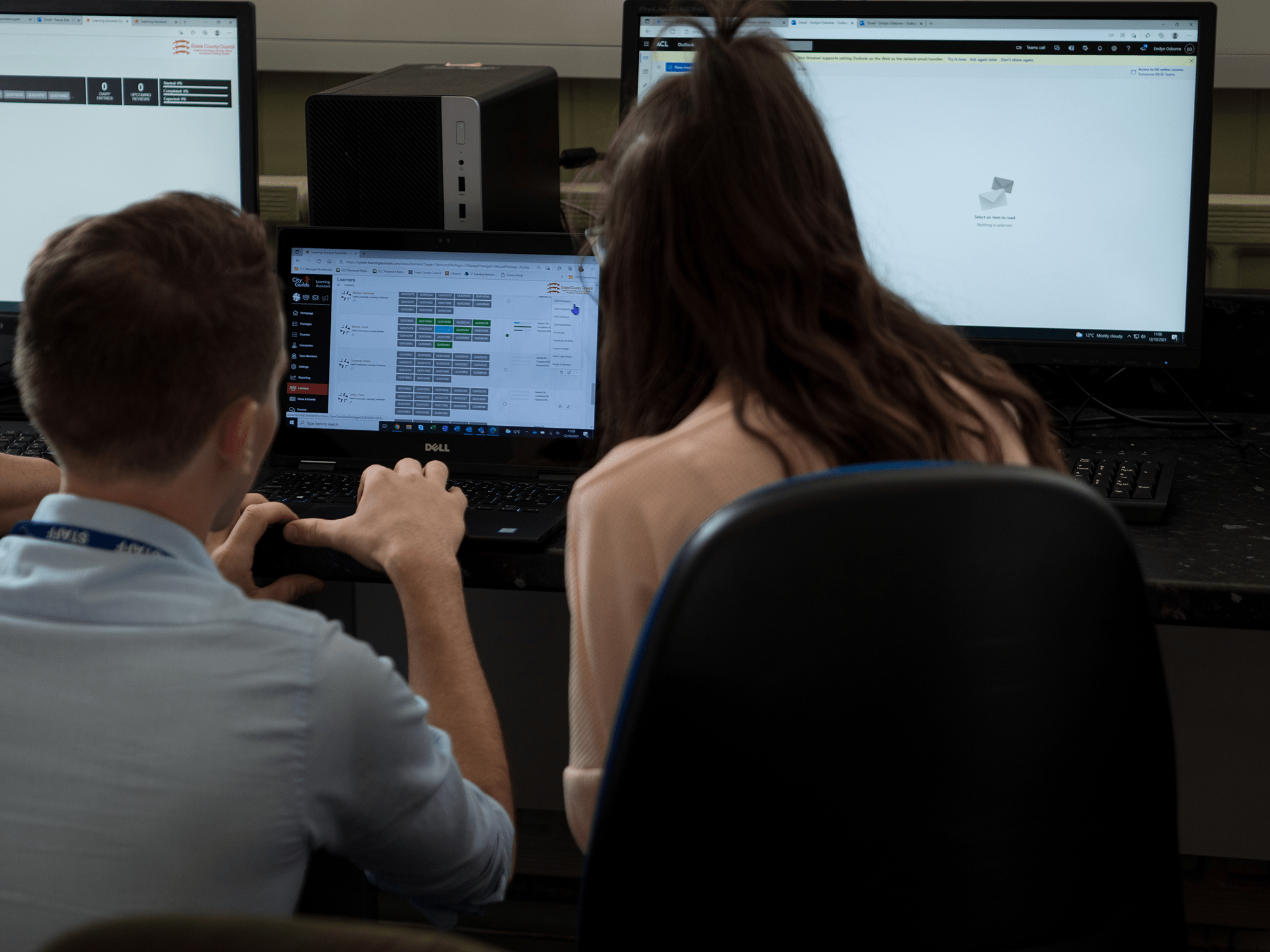 tutor helping student on computer